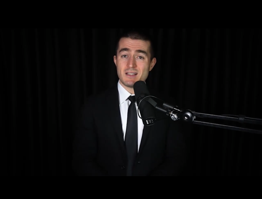 Lex Fridman in a black suit and black background