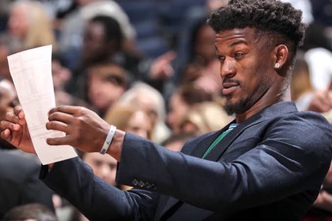 Man Looks very carefully at a sheet